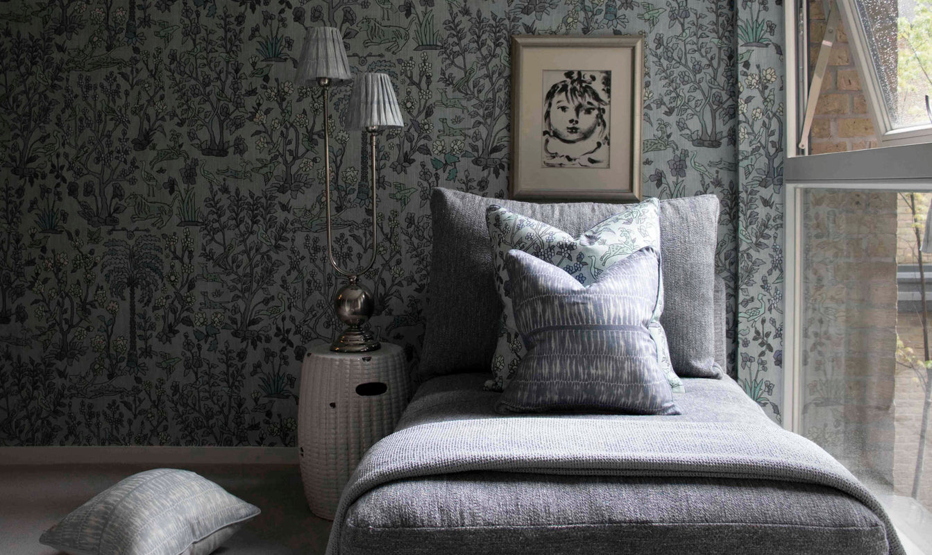 The Vale Home living room with beautiful pillows and wallpaper in coordinating blue hues