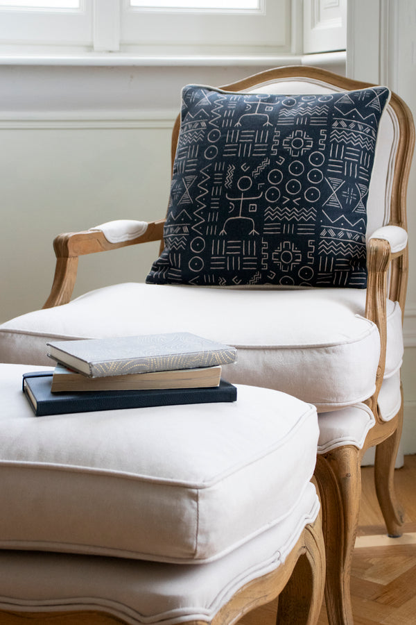 Gorgeous navy Dogon printed pillow atop an armchair